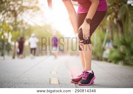 Runner Sport Knee Injury. Woman In Knee Pain While Running Work Out In Park. Health Care Concept.