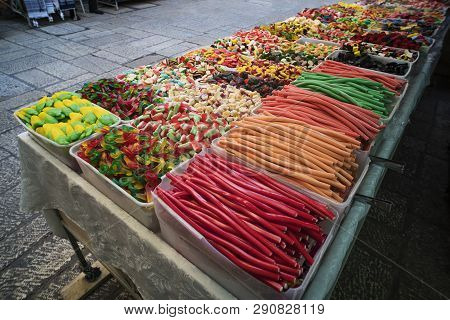Various Colorful Jelly Sweets And Confectionary Exposed In Plastic Boxes For Sale In The Street. Con