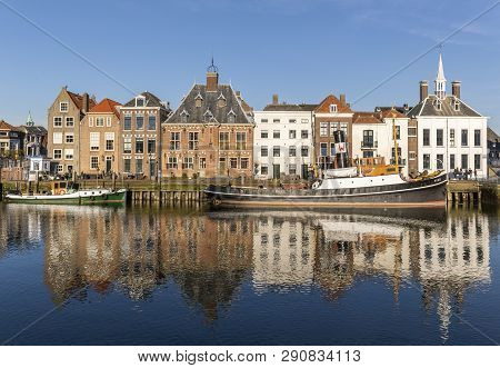 Maassluis, The Netherlands - February 26, 2019: The Harbor Of Maassluis With Old Boats, Tugs And Mon