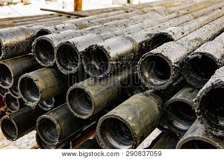 Oil Drill Pipe. Rusty Drill Pipes Were Drilled In The Well Section. Downhole Drilling Rig. Laying Th
