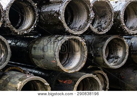 Oil Drill Pipe. Rusty Drill Pipes Were Drilled In The Well Section. Downhole Drilling Rig. Laying Th