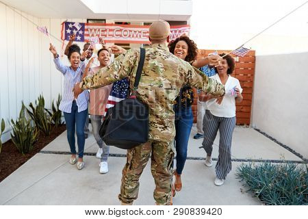 Three generation black family welcoming back millennial soldier returning home,back view