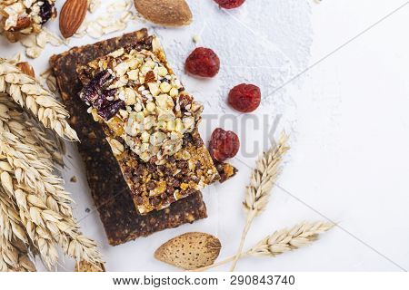 Assortment Of Different Granola Cereal Bars On White Stone Background. Healthy Pre Or Post Workout S