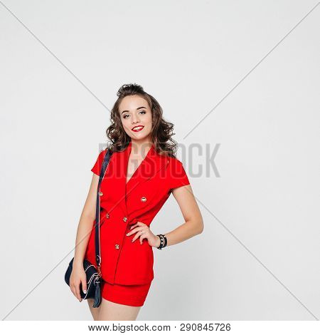 Beautiful Woman In Red Suit And Bag Showing Thumb Up.