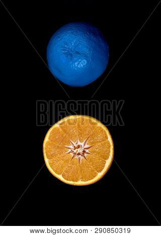 Slices Of  Blue And Orange Fresh Citrus Orange Fruit On A Black Background. Still Life Crative Photo