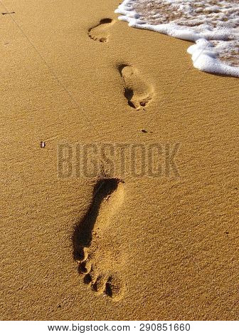 Lonely Footprint At The Beach. Trace At Sand And Sea Wave. Peaceful Lonely Mood. Psychology Or Phylo
