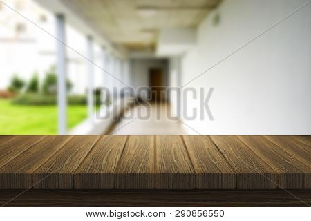 Wooden Brown Table Top Against The Blurred Corridor, Passage And Courtyard Of The House .for Product