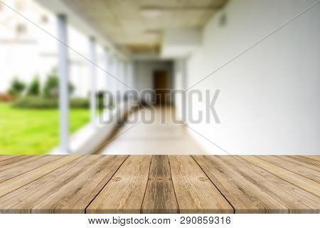 Wooden Brown Table Top Against The Blurred Corridor, Passage And Courtyard Of The House .for Product