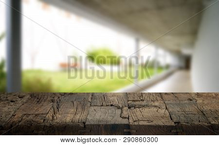 Wooden Brown Table Top Against The Blurred Corridor, Passage And Courtyard Of The House .for Product