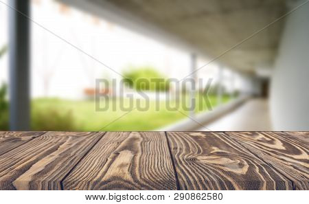 Wooden Brown Table Top Against The Blurred Corridor, Passage And Courtyard Of The House .for Product
