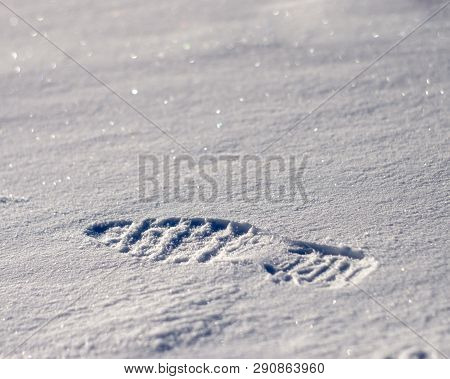 Winter Background With Footprint On The Snow