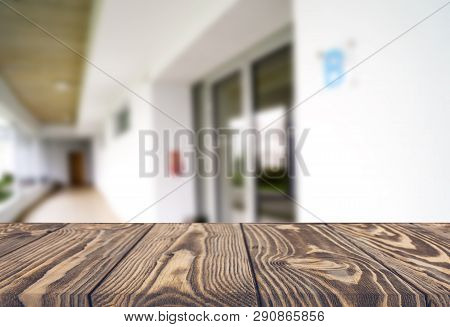 Wooden Brown Table Top Against The Blurred Corridor, Passage And Courtyard Of The House .for Product