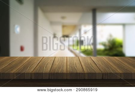 Wooden Brown Table Top Against The Blurred Corridor, Passage And Courtyard Of The House .for Product