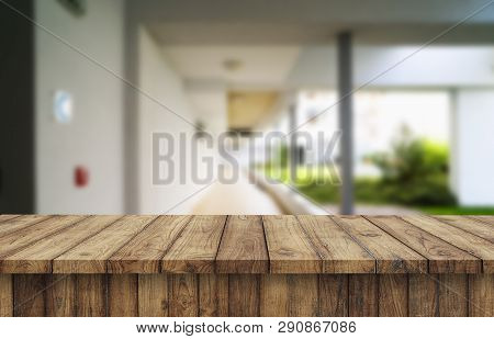 Wooden Brown Table Top Against The Blurred Corridor, Passage And Courtyard Of The House .for Product