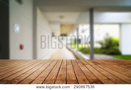 Wooden Brown Table Top Against The Blurred Corridor, Passage And Courtyard Of The House .for Product