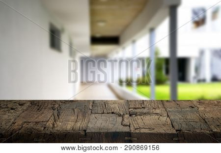 Wooden Brown Table Top Against The Blurred Corridor, Passage And Courtyard Of The House .for Product