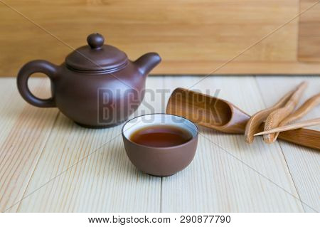 A Set Accessories For The Tea Ceremony. Dishes For Tea And Wooden Sticks On A Light Background