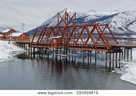 Carcross, Yukon, Canada, March 9, 2019 : Railway Bridge Over The River. Carcross Is An Unincorporate