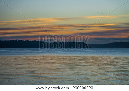 A View Of A Hazy Sunset With A Fence From West Seattle, Washington.