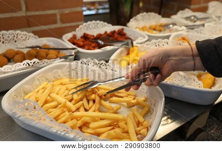 Self Service In The School With Yellow Hot Chips And More Foods And The Hand Of Little Girl