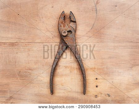 A Slip Joint Pliers On A Wooden Table