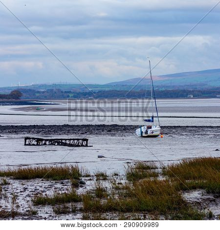 At Low Tide On The River Lune In Lancashire, England Boats Become Grounded In The Sand