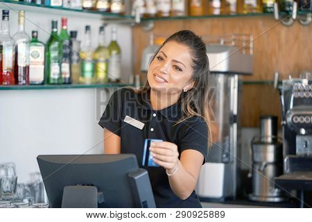 Bartender Registrating New Order By Cash Register. A Restaurant Worker Registrating New Order By Cas