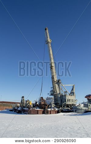 Grey Crane In Port. Winter Industrial Landscape
