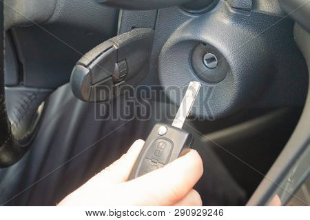 Closeup Inside Vehicle Of Hand Holding Key In Ignition, Start Engine Key