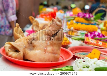 Boiled Pig Head In Ritual Sacrifice Or Votive Offering According To Asian Religion People Beliefs.