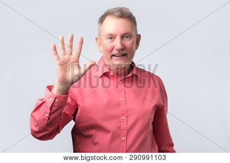 Senior Man In Red Shirt Wave Hand, Welcome
