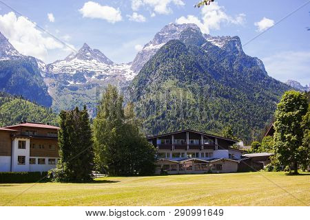 An Old, Vintage, Wooden House Is Located In The Alps