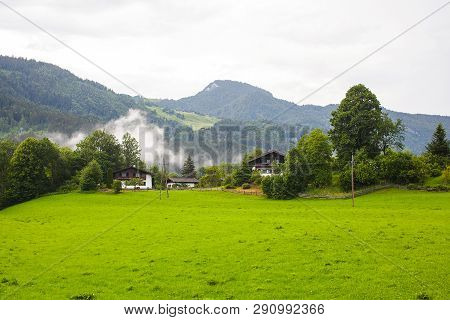 An Old, Vintage, Wooden House Is Located In The Alps