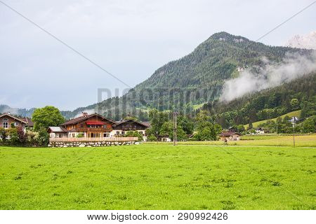 An Old, Vintage, Wooden House Is Located In The Alps