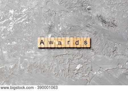 Awards Word Written On Wood Block. Awards Text On Cement Table For Your Desing, Concept