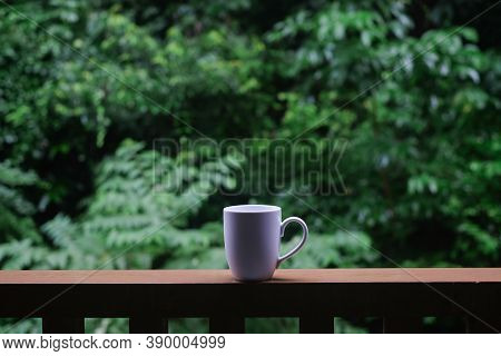 Cup Of Black Coffee In The Morning And Nature Tree Mountian Background