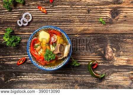 Shurpa Soup In Plate With Oriental Ornament, Wooden Background. Top View. Traditional Asian, Uzbek, 