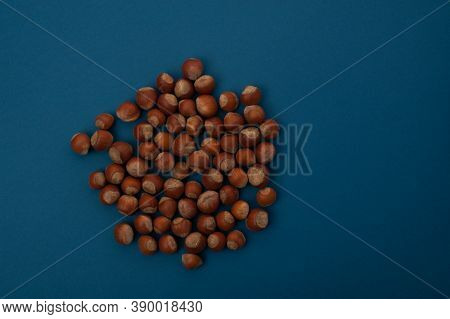 Nuts In A Pile Lie On A Blue Background