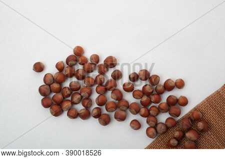 Nuts Scattered From The Corner On A White Background