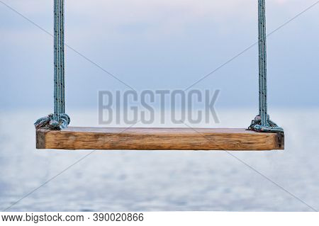Wooden Swing With Ropes Overlooking The Sea. Swing On Seashore. Close Up.
