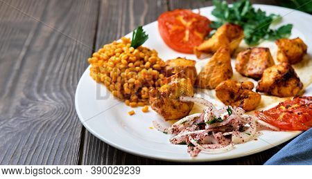 Light And Delicious Grilled Chicken Kebab, Located On A Platter With Tomato And Bulgur, Decorated Wi