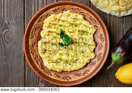 Grilled Eggplant Salad With Garlic, Lemon And Olive Oil In A Clay Bowl On A Dark Wooden Background. 