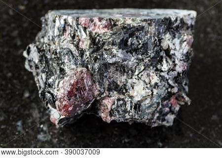 Macro Photography Of Sample Of Natural Mineral From Geological Collection - Raw Garnet Crystals In B