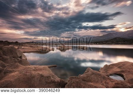 Long Exposure Wide Angle Image Of Dawn Breaking Over The Lac De Codole And Distant Mountains In The 