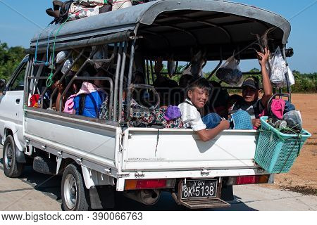 Chaung Thar, Myanmar - December 26, 2019: A Truck Filled With Unidentified People Drives On An Aspha