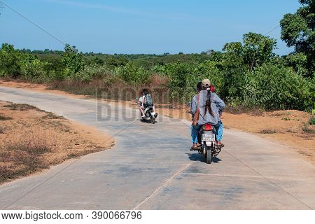 Chaung Thar, Myanmar - December 26, 2019: Unidentified People Drives Motorbikes On A Rural Asphalt R