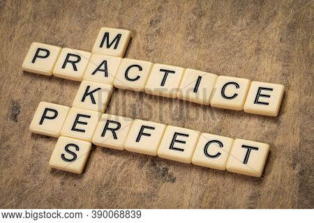 practice makes perfect crossword in ivory letters against textured bark paper, education and training concept