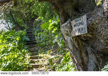 Waiheke Island New Zealand - October 6 2020;  Wrong Way Sign Beside Path And Steps Leading Upwards A