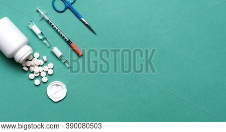 Pills, Ampoule, Syringes, Capsules, Stethoscope On The Green Doctor S Table. Copy Space. Place For T