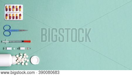 Pills, Ampoule, Syringes, Capsules, Stethoscope On The Green Doctor S Table. Copy Space. Place For T